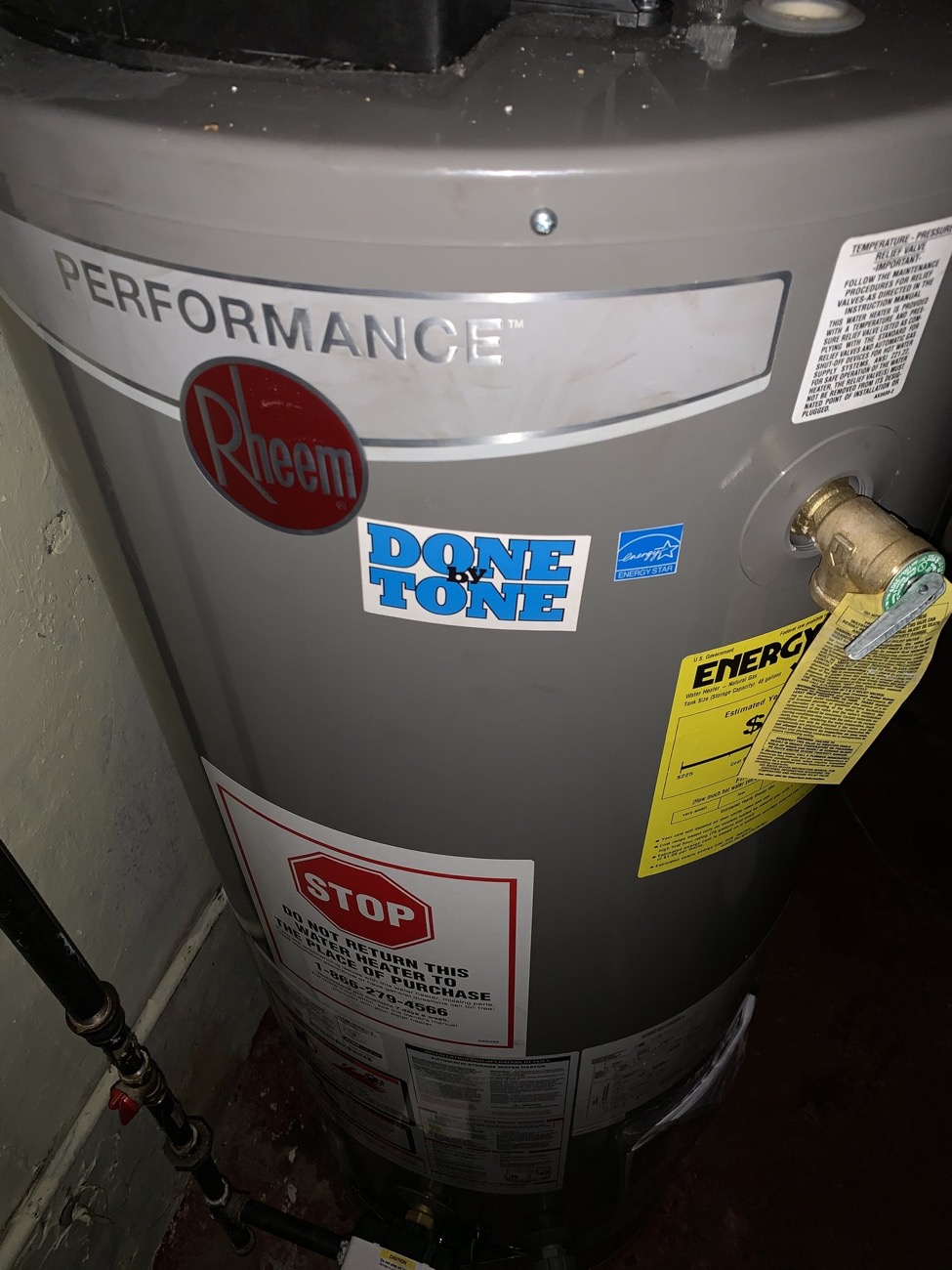 Rheem water heater with the Done by Tone sticker after install